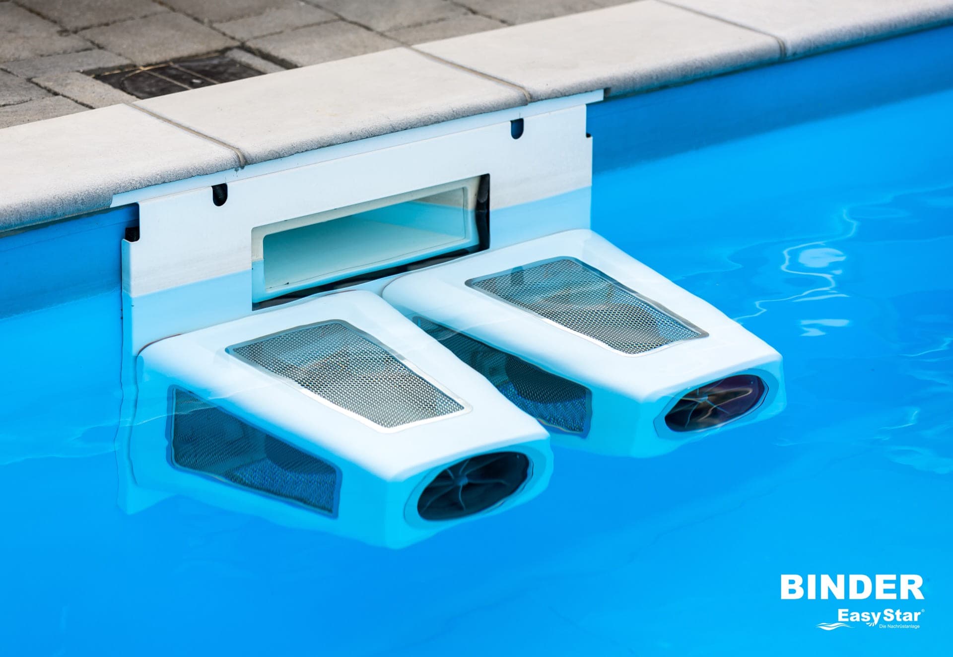 Binder EasyStar double turbine unit mounted on a pool edge, viewed from above at an angle, showing the bracket and twin turbine housings in clear blue water