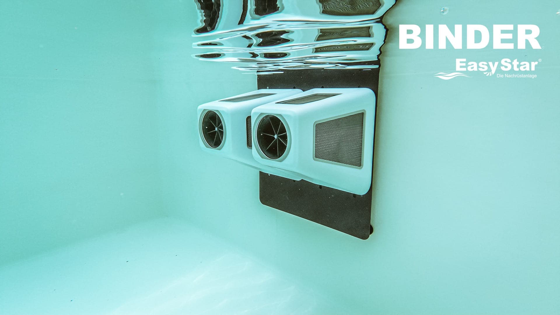 Binder EasyStar counter-current turbine unit mounted underwater in a pool, showing dual turbine outlets and water surface reflections
